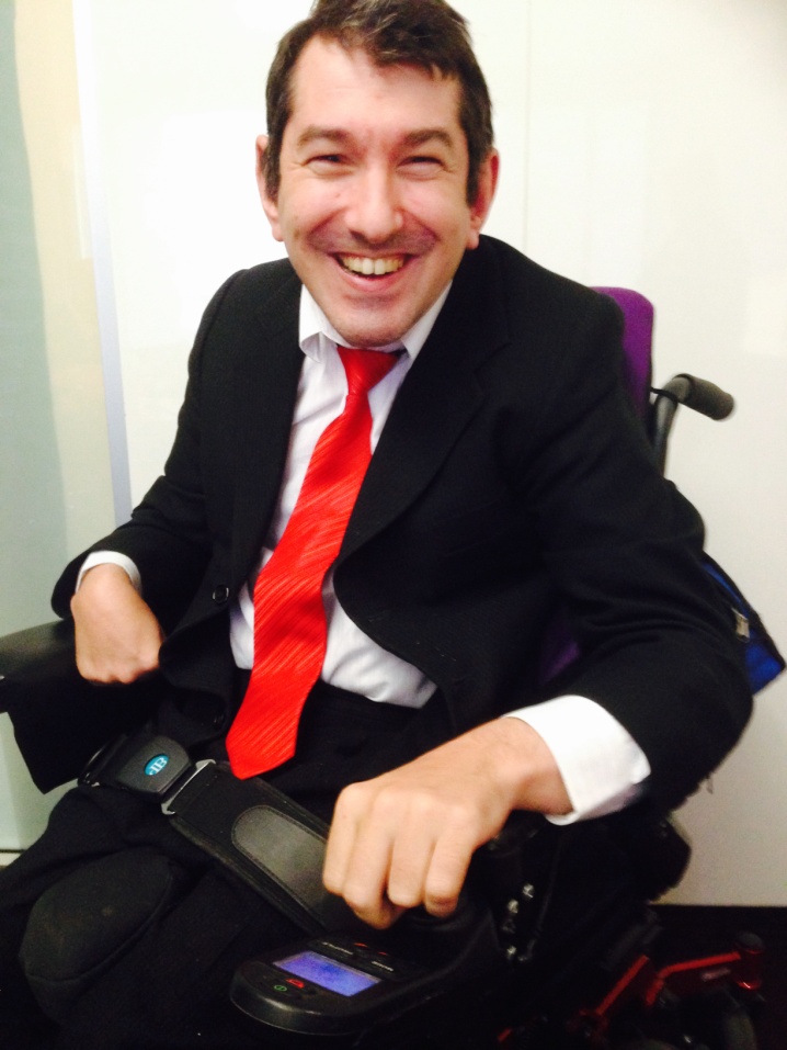 Alex Xeras smiling in his wheelchair